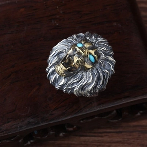 Men's retro lion head ring with silver and gold metal finish and turquoise eyes