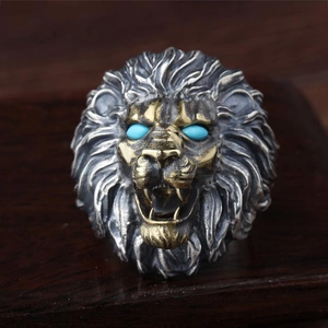 Retro punk lion head ring in silver and gold finish with blue gemstone eyes