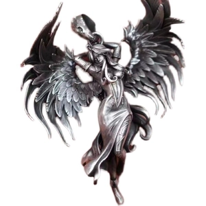 Detailed macro view of vintage silver gothic angel wings pendant with intricate carving details