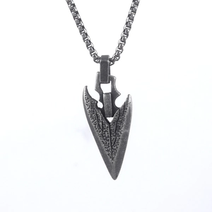 Close-up of vintage Viking spearhead pendant with oxidized finish and box chain
