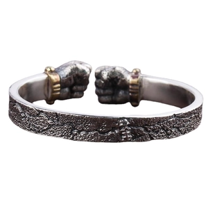 Vintage mens silver fist open bangle with skull detail and rugged rock texture finish
