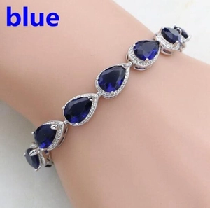 Fashionable silver bracelet with blue pear-shaped gemstones and zircon inlay
