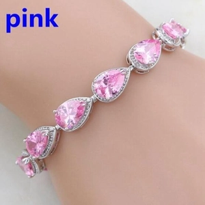 Detailed view of silver-tone bracelet featuring pear-cut pink gemstones with halo diamonds