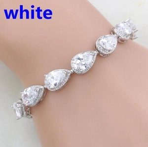 Close-up of a silver-tone bracelet featuring pear-cut white stones in a cluster design