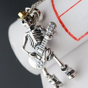 Rock punk skeleton playing guitar pendant necklace in vintage silver with gold hat detail