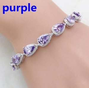 Close-up of a pear-cut purple gemstone bracelet with white zircon pave on the wrist