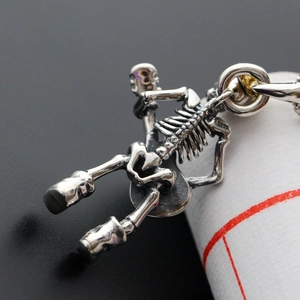 Macro shot of S925 sterling silver guitar skeleton pendant with vintage oxidized finish
