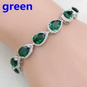 Elegant silver bracelet with teardrop green gemstones and zircon halo on wrist