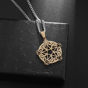 Macro shot of gold pentagram tree of life pendant on a luxury black leather texture gift box
