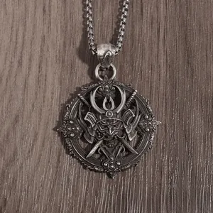 Detailed macro view of vintage gothic samurai helmet pendant with crossed swords on a dark chain