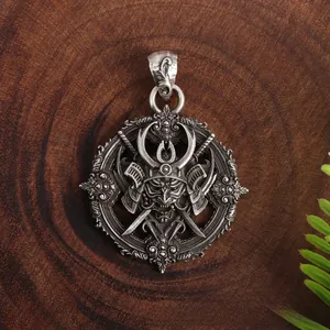Detailed close-up of retro silver samurai mask and cross swords pendant on wood base