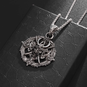 Close-up detail of gothic samurai demon pendant with intricate engraving on black texture