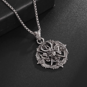 Close-up of vintage silver samurai helmet and katana embossed pendant on chain