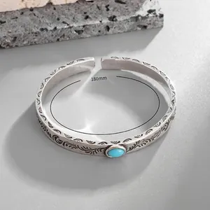 Detail view of vintage silver feather engraved bangle with turquoise inlay and 180mm inner size