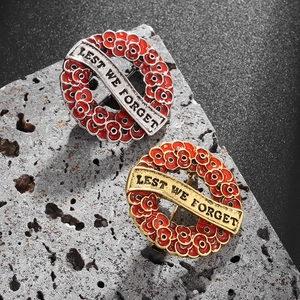 Red poppy wreath brooches in gold and silver finish with Lest We Forget engraving