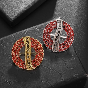 Vintage poppy flower wreath brooch with Lest We Forget engraving in gold and silver