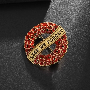 Vintage gold poppy wreath brooch with Lest We Forget text and red enamel finish