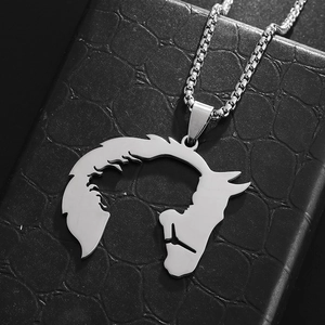 Detailed close-up of hollowed-out horse head pendant on stainless steel box chain