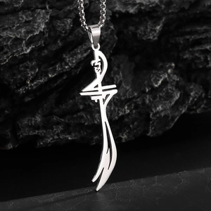 Macro shot of silver stainless steel Zulfiqar sword pendant on black stone surface