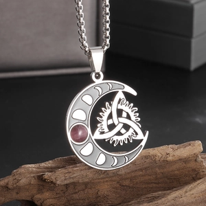 Detail of hollow moon Celtic knot pendant with purple gemstone on stainless steel chain