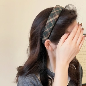 Detail of retro plaid headband in green and brown tweed fabric worn on model