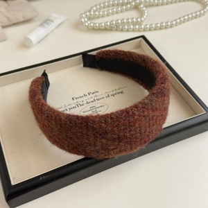 Detail of reddish brown tweed wide headband with soft texture in elegant display box