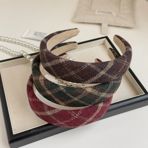 Detailed close-up of retro plaid fabric headbands in burgundy, green, and brown colors