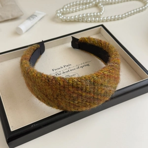 Close-up of thick tweed knit headband texture in mixed ginger green and brown wool