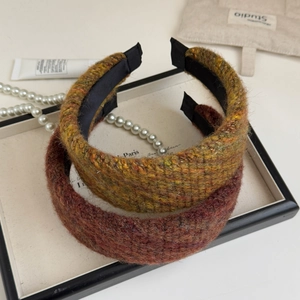 Detail of thick tweed headbands in brown and yellow-green with non-slip inner lining