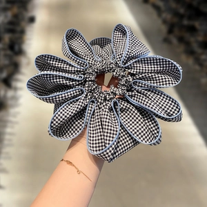 Oversized houndstooth gingham scrunchie with blue piping detail in a floral petal shape
