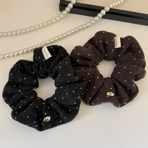 Detail of vintage polka dot velvet scrunchies with gold bow charms and handmade labels