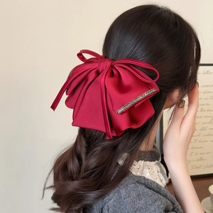 Elegant oversized burgundy satin bow hair claw with sparkling rhinestone details