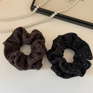 Close-up of vintage polka dot velvet scrunchies in coffee and black with white pearls