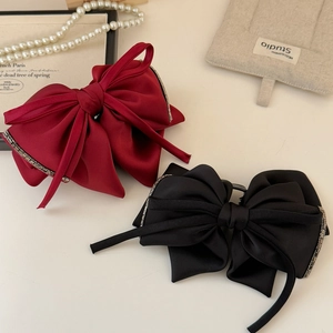 Elegant satin bow hair claw clips in red and black with luxury rhinestone edges