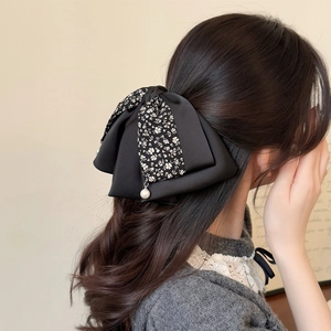 Elegant double-layered black bow hair clip with floral pattern and pearl pendant