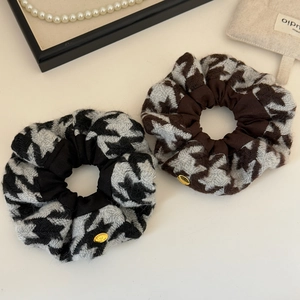 Elegant houndstooth knit hair scrunchies set with a delicate golden metal logo charm