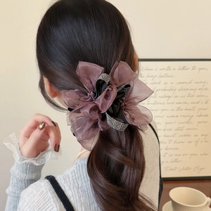 Elegant oversized brown mesh flower hair scrunchie with rhinestones on low ponytail