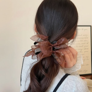 Detail of coffee mesh bow hair scrunchie with rhinestones on model ponytail