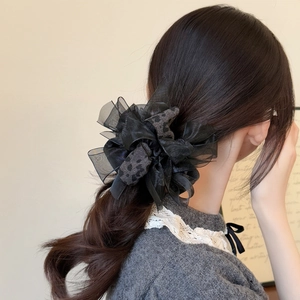 Elegant black mesh organza scrunchie with leopard print ribbon on a stylish ponytail