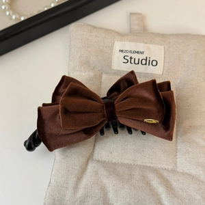 Detail of coffee velvet double layer bow hair claw clip with golden metal ring