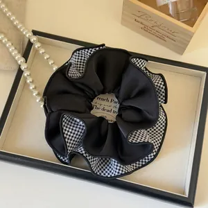 Classic large black and white checkered scrunchie with elegant double-layered satin fabric