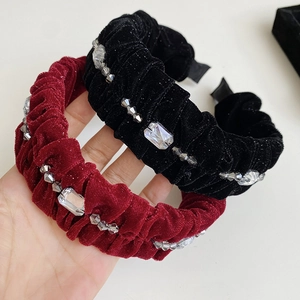 Detail showing plush velvet texture with crystals and beads on pleated fashion headbands