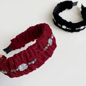 Detail of pleated velvet headbands with sparkling crystal beads in black and burgundy red