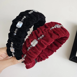 Detail of velvet padded headbands with rhinestone embellishments in black and burgundy