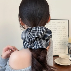 French style black and white houndstooth hair scrunchie shown on a ponytail with elegant vibe