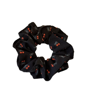 Sweet black hair scrunchie with red cherry and white bow prints on soft fabric
