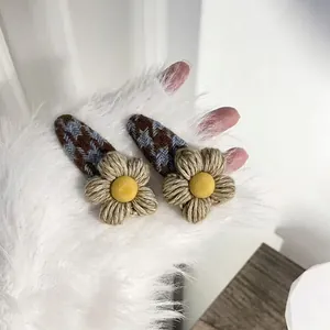 Houndstooth floral hair clips set with knit flower details for elegant winter styling