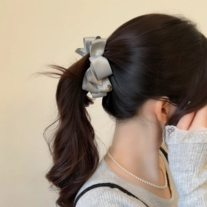 Elegant silver-grey satin bow hair clip with multi-layered design for high ponytail styles