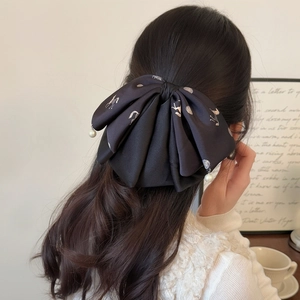 Elegant black satin bow hair clip with pearl charms and horse print for women