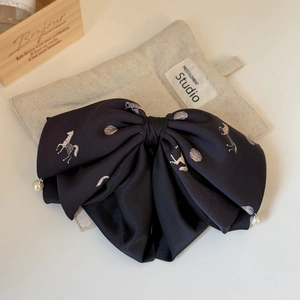 Elegant black satin bow hair clip with white horse print and hanging pearl charms